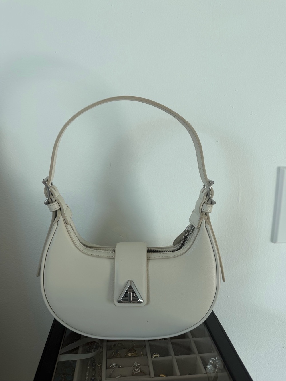 Charles & Keith Cream Leather Crescent Shoulder Bag with Silver Accent